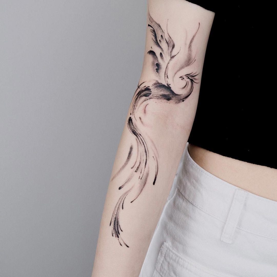 Tatuaje de ave fénix en el brazo